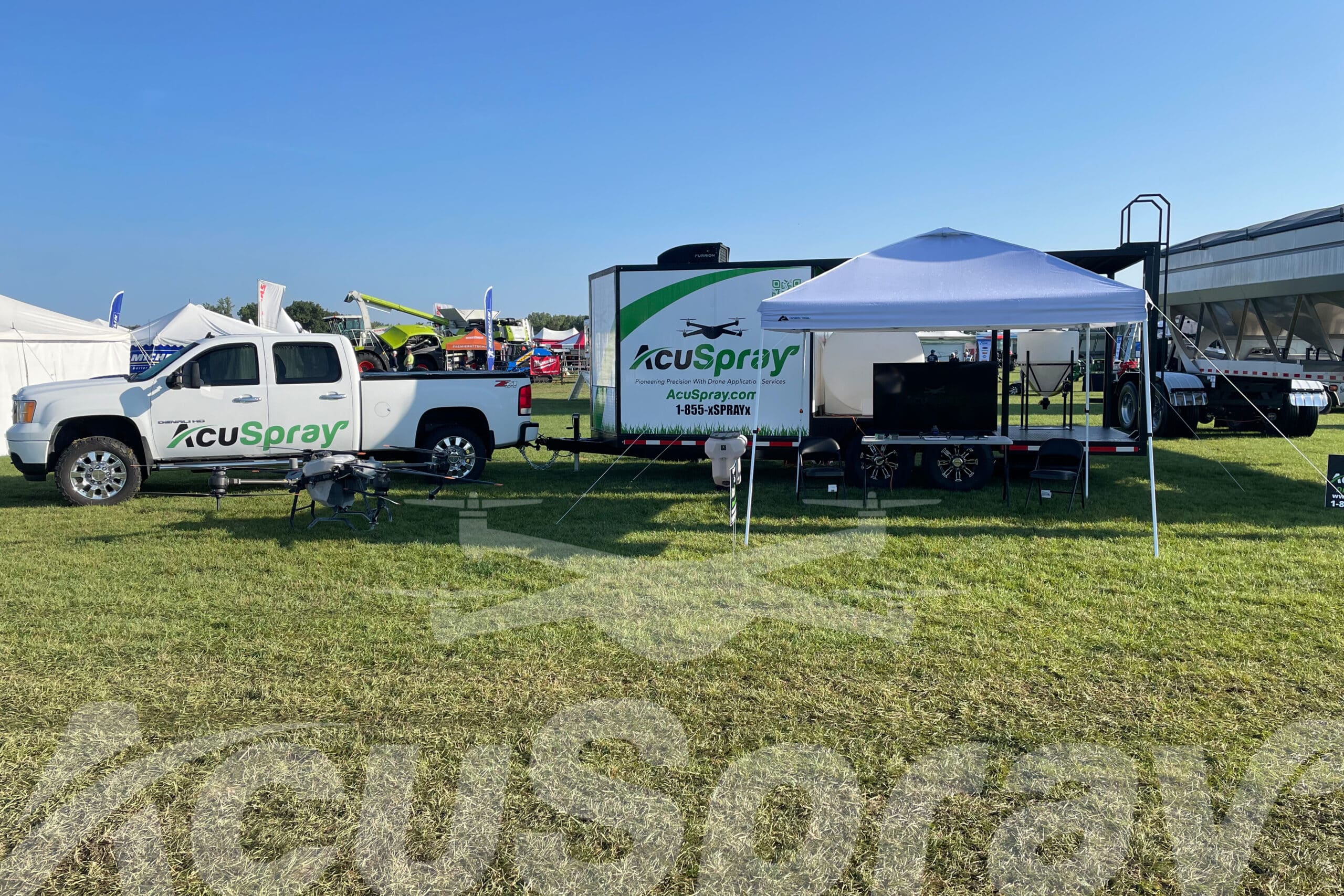 AcuSpray drone, truck, and trailer display at AgroExpo in St. Johns