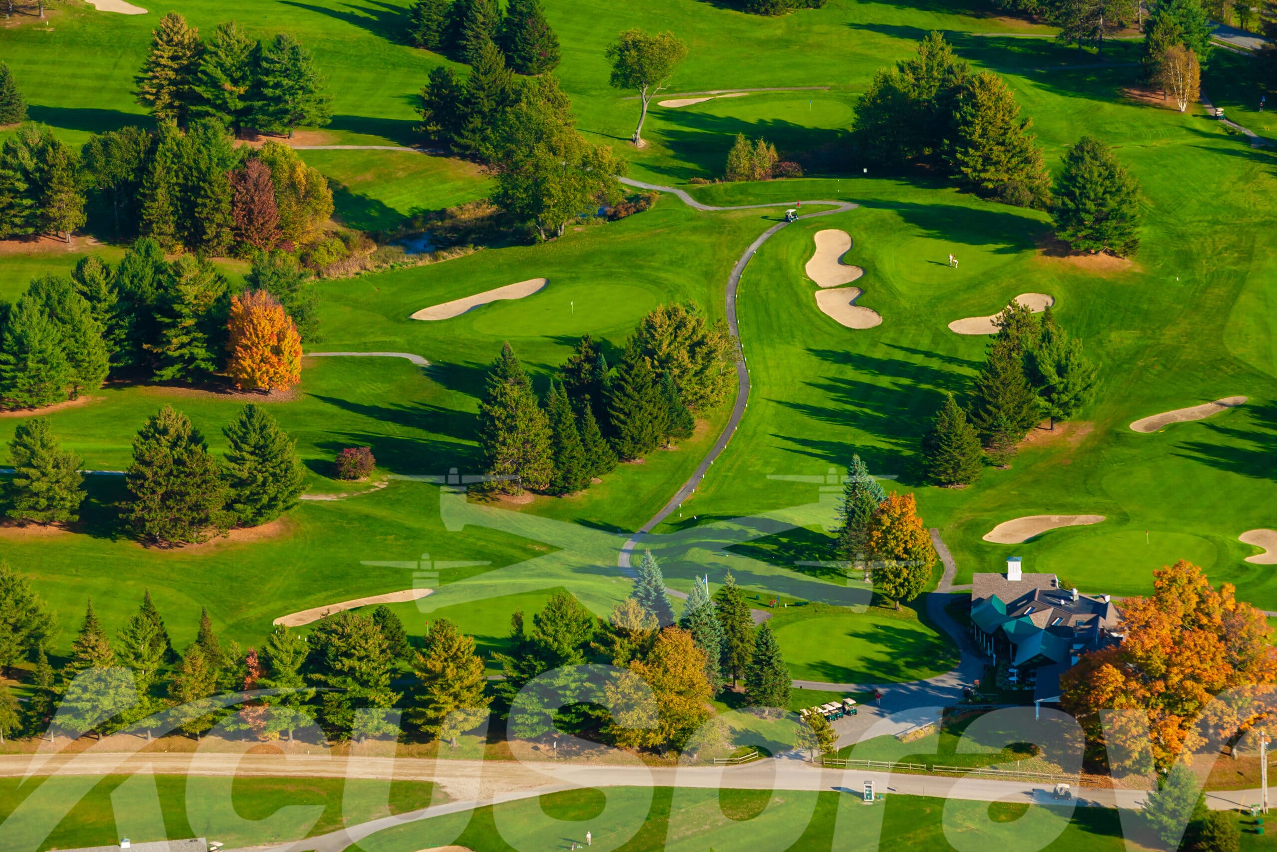 Aerial view of a golf course during autumn, highlighting the mastery of Northeast Turf Management.
