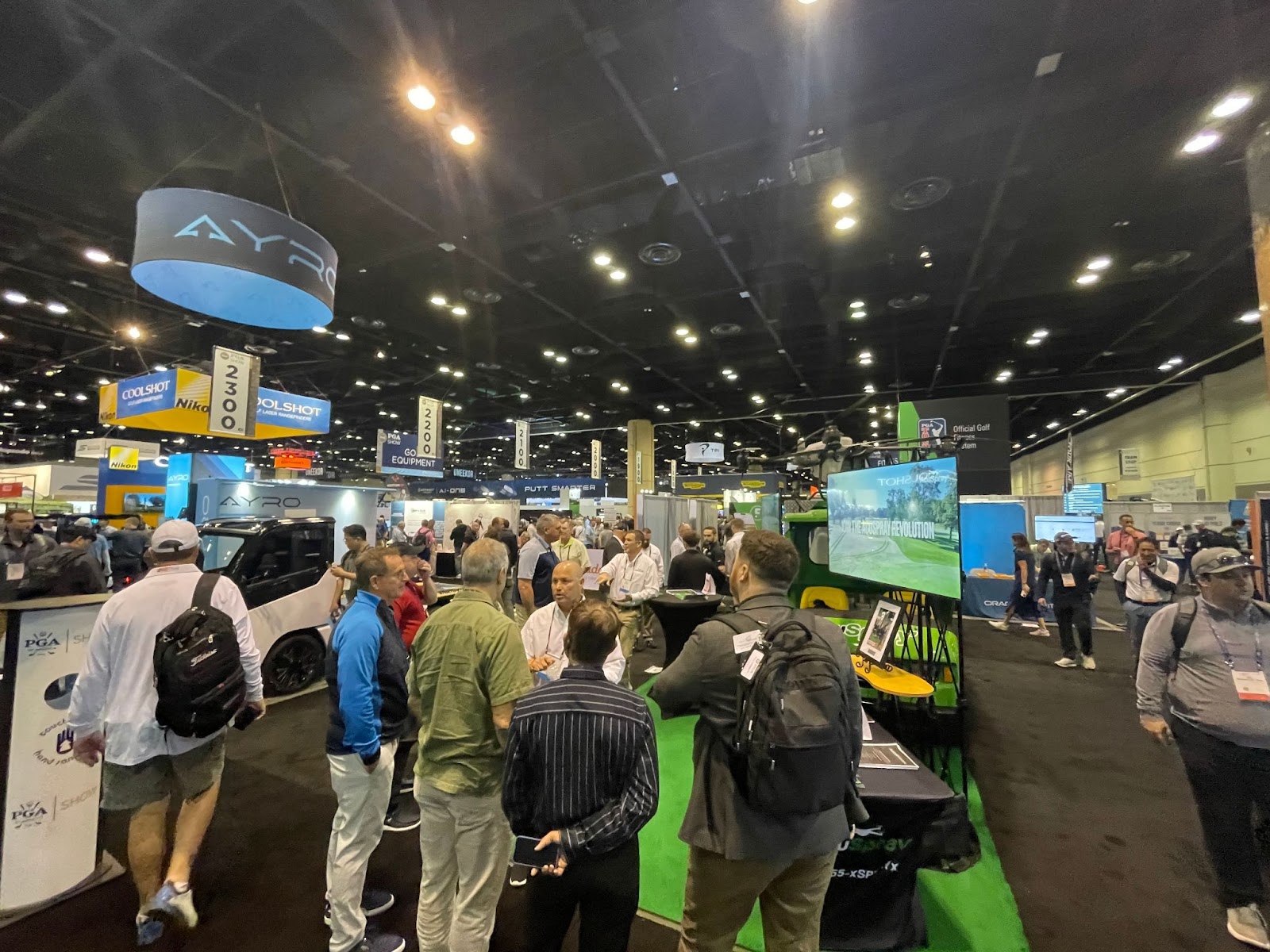 AcuSpray team at PGA Show in Florida, demonstrating Spray Drone technology for innovative golf course management.